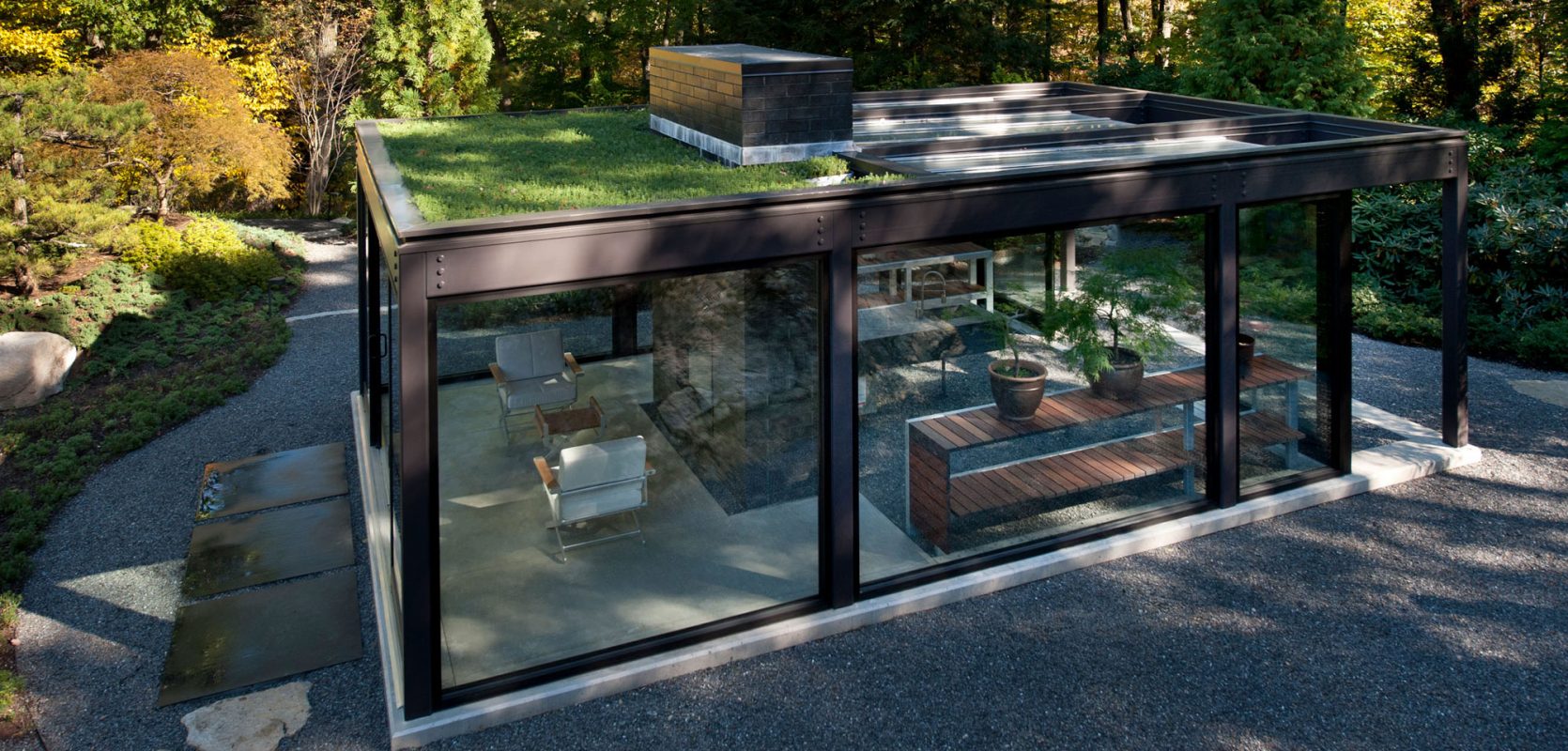 glass steel house with live garden roof